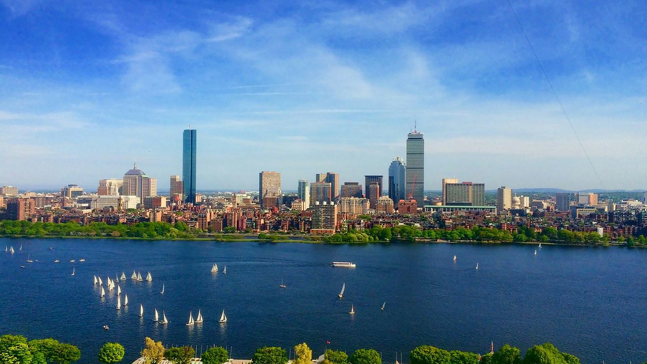 Boston skyline across the Charles River with sailboats on the water