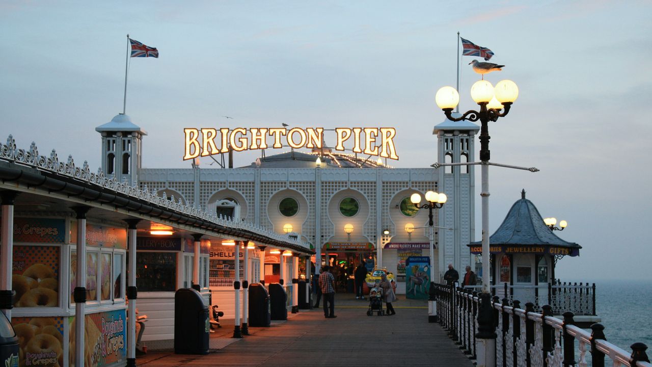 Brighton Palace Pier entrance lit up at dusk