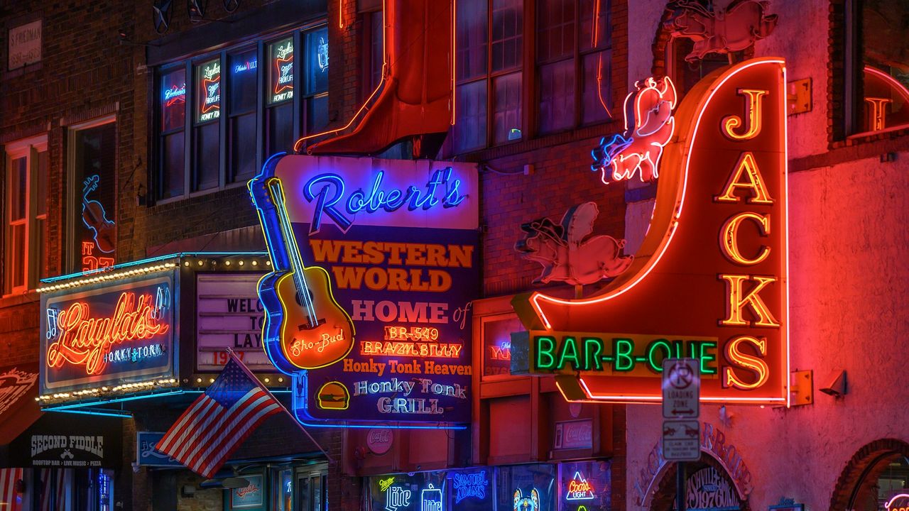 Neon honky-tonk signs on Broadway in Nashville at night