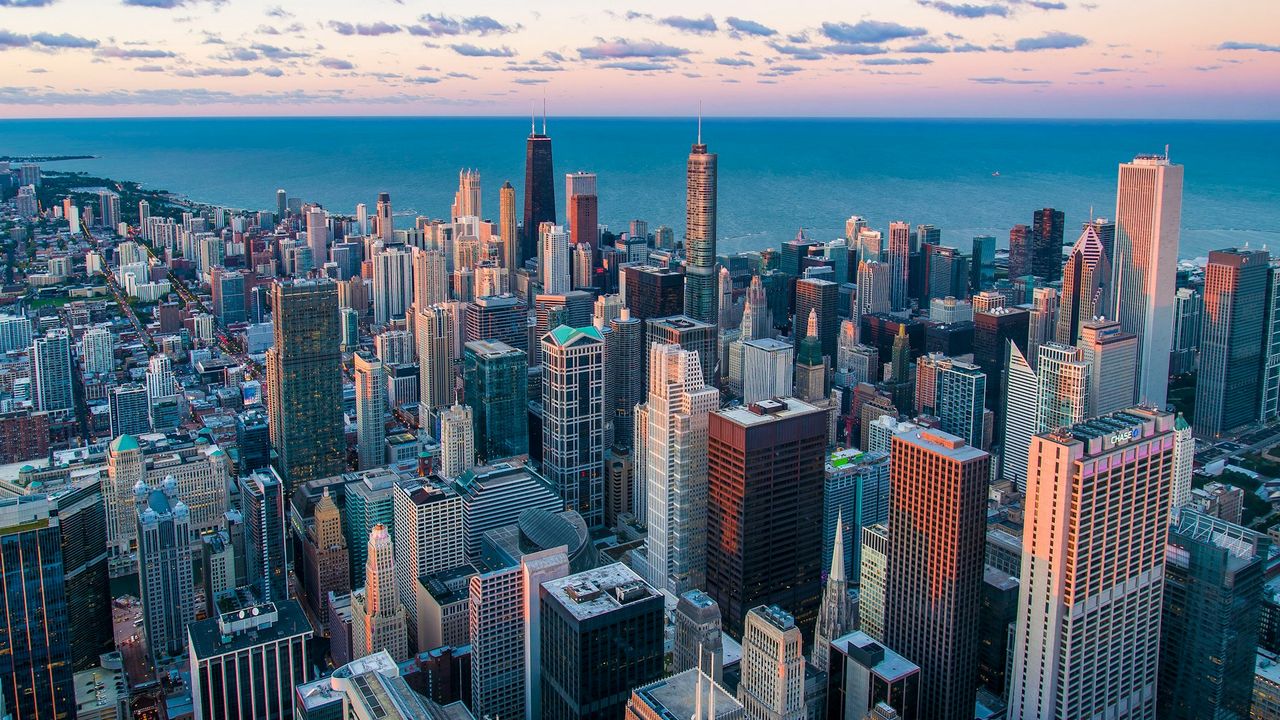 Aerial view of the Chicago skyline beside Lake Michigan at sunset