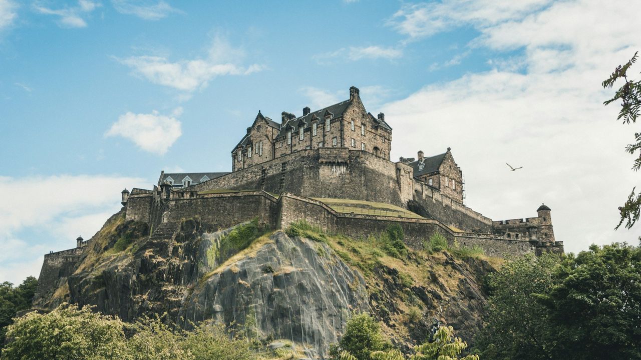 Edinburgh Castle on Castle Rock against a blue sky