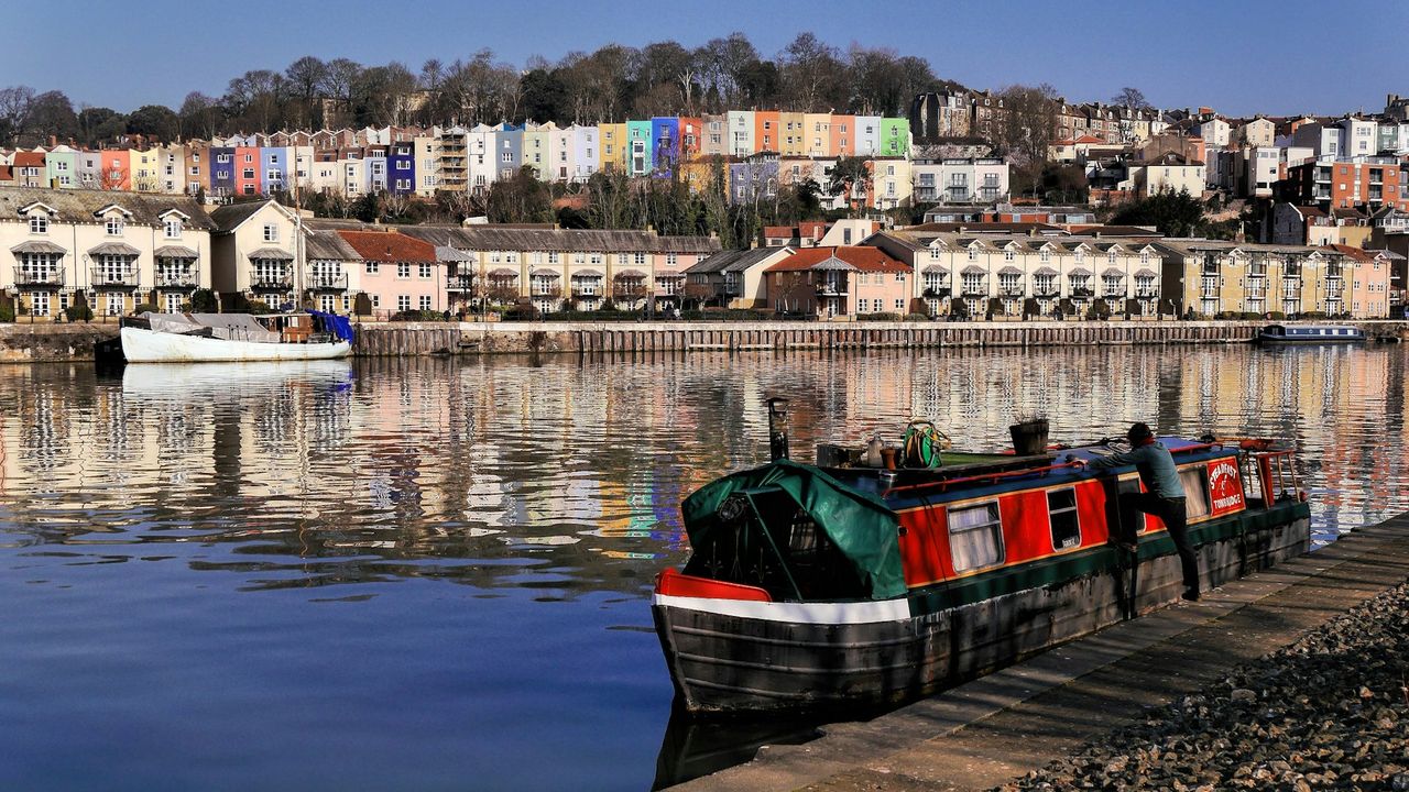 Colourful Bristol harbourside houses reflected in the water