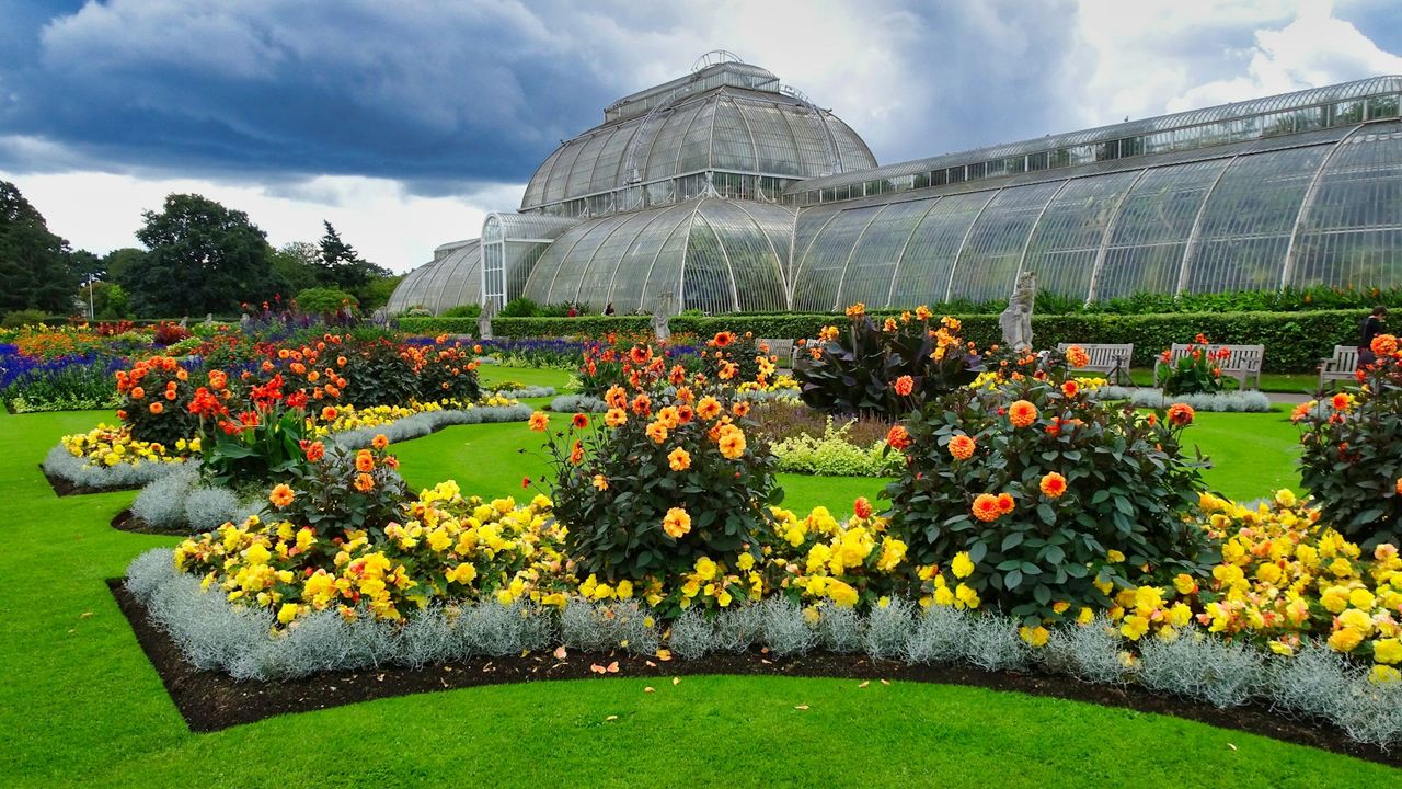 Kew Gardens glasshouse with colourful flower beds